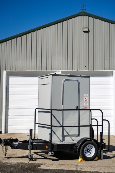 Outside the home in NY & NJ, parked a portable two-station restroom trailer 