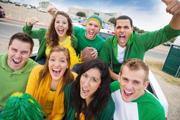 Group of friends cheering at a tailgate